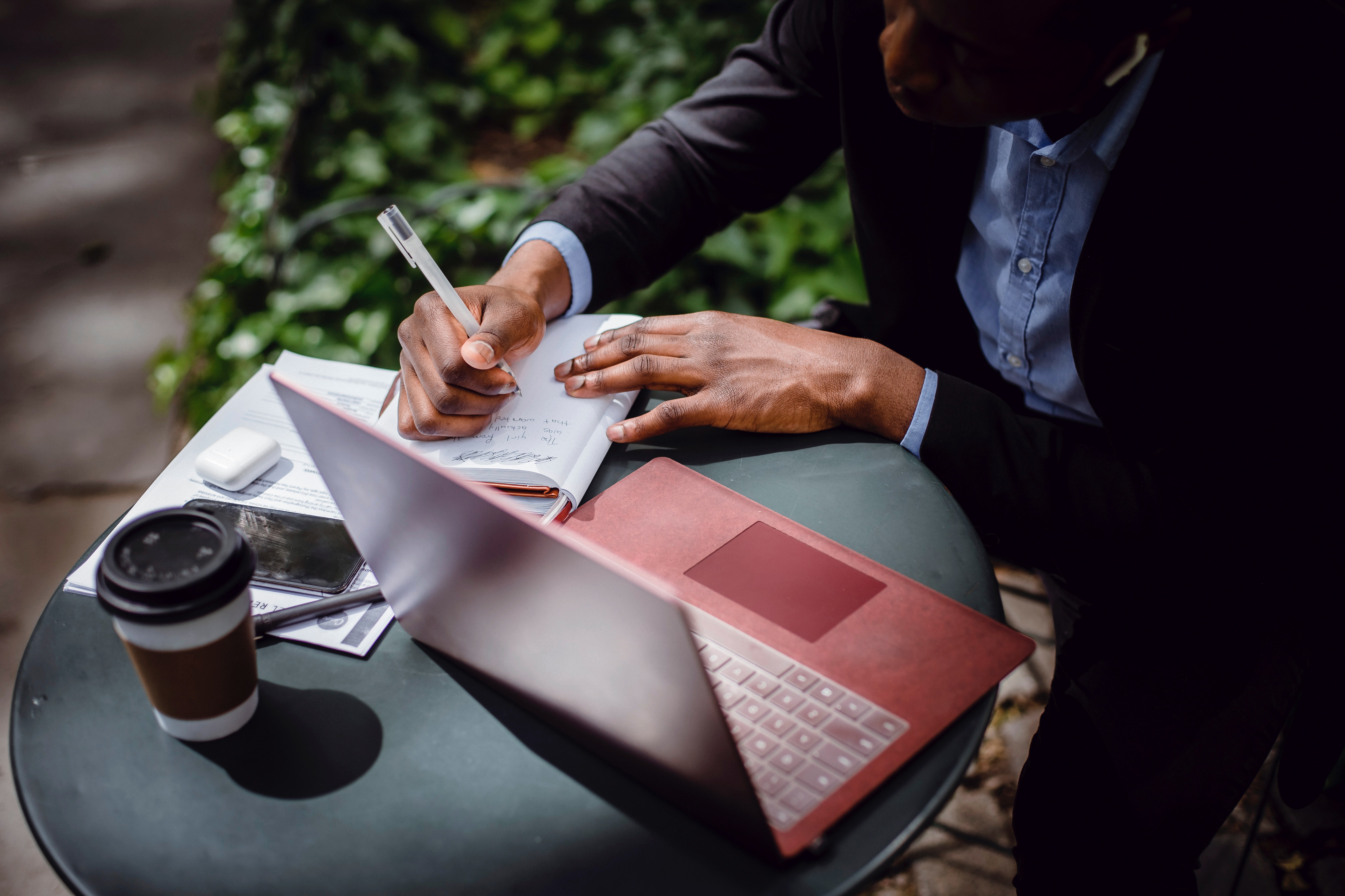 man writing on desk